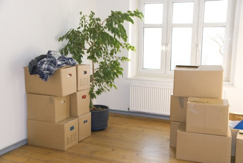 Packed moving boxes and furniture inside a Sutton flat